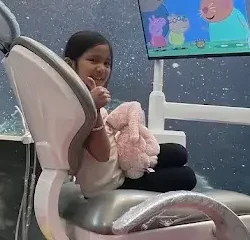 A smiling child giving a thumbs up at HealthLand Whitefield